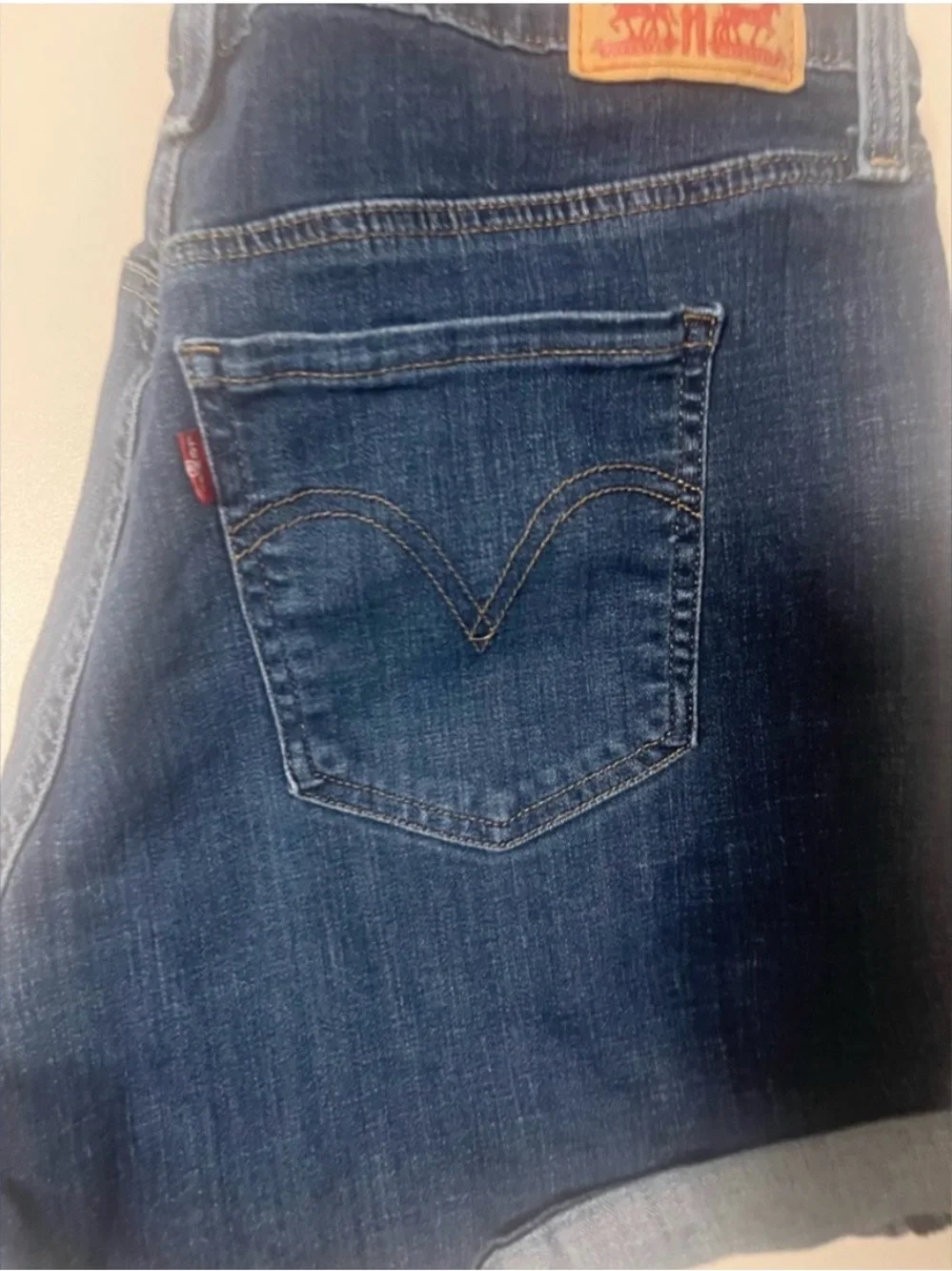 Levi's Dark Blue Denim with Tan Stitch Button Close-Up - Picture 3 of 9